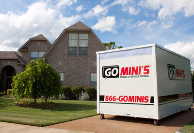 A Go Mini's shipping moving container in a residential driveway